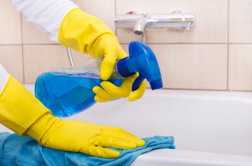 Cleaner working in a modern apartment in Ealing with access considerations