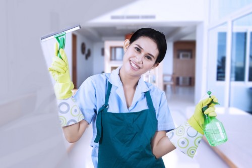 Cleaner wiping kitchen surfaces during a short-let turnover in Ealing